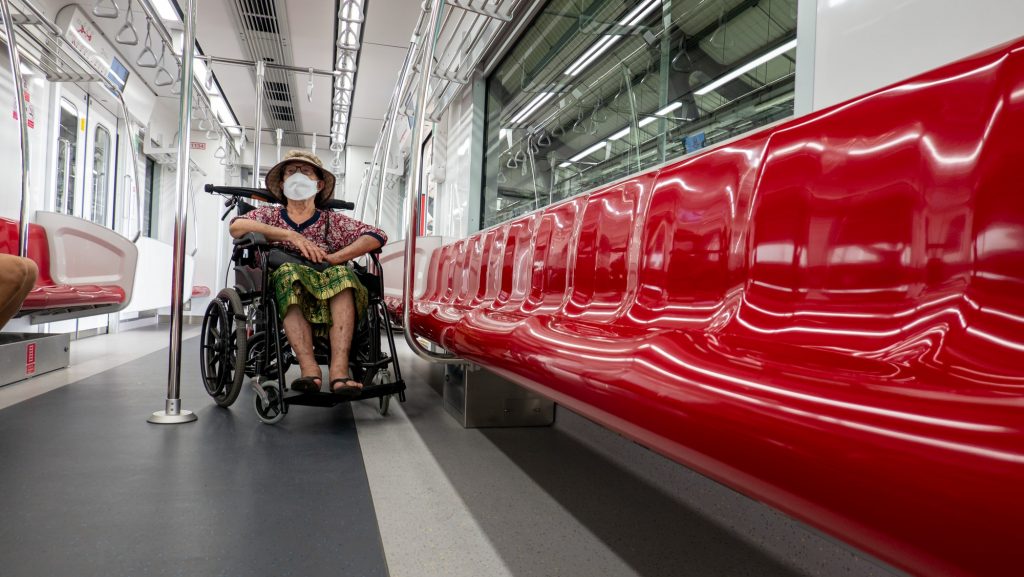 Senior Disabled person in wheelchair on traveling in train for transportation.