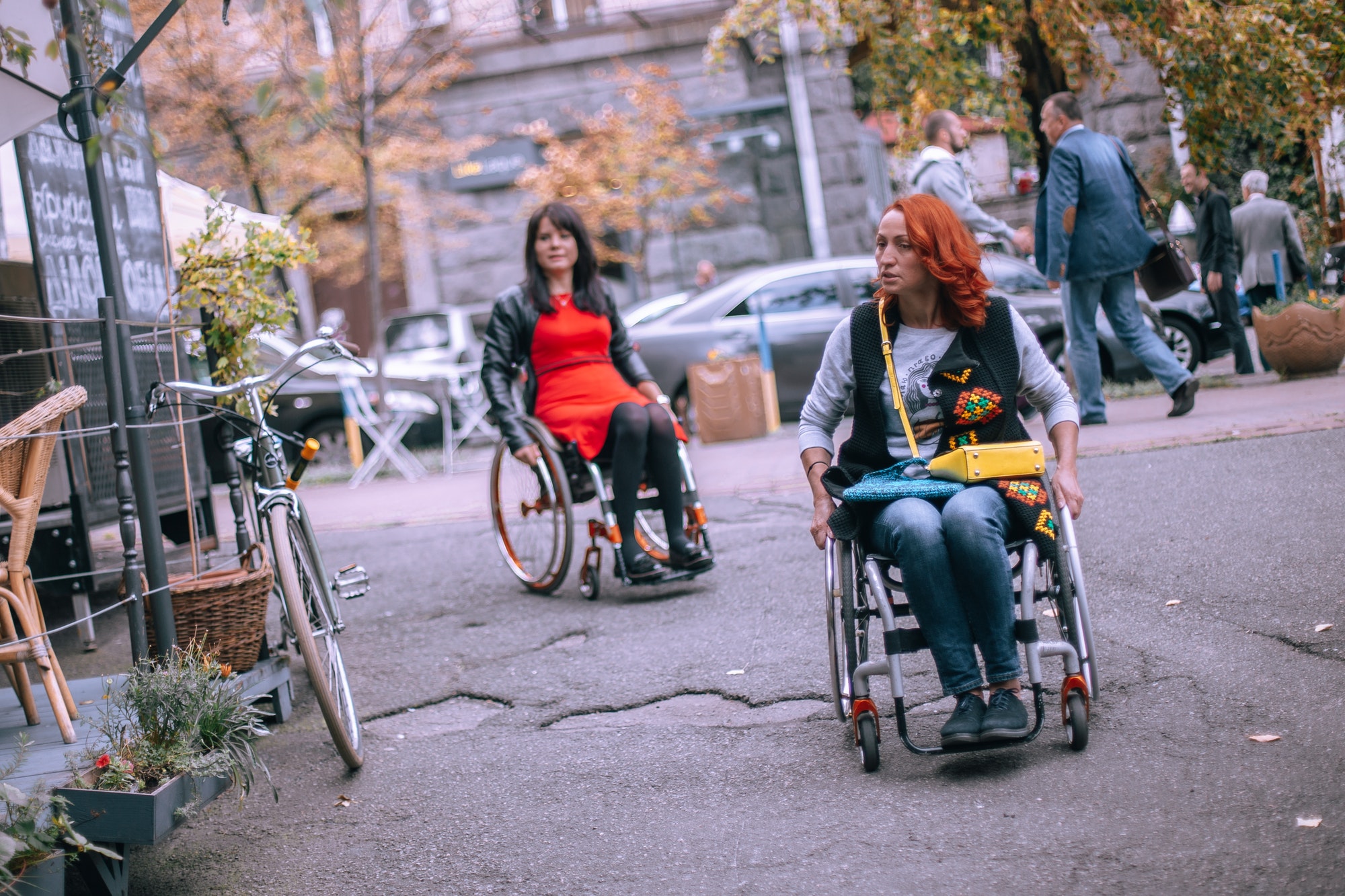 Two girls in wheelchairs are looking for a cafe accessible for people with disabilities
