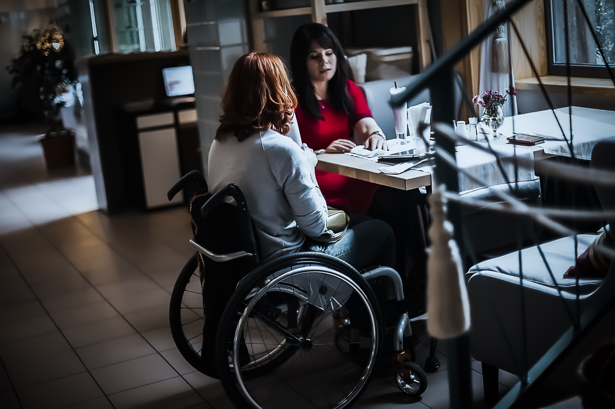 two-girls-in-wheelchairs-in-a-cozy-cafe-waiting-fo-2021-12-03-19-37-07-utc